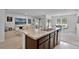 Open concept kitchen with island seating flowing into the living and dining areas at 1351 Fox Squirrel Dr, Davenport, FL 33897