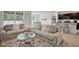 Comfortable living area featuring plush seating, round glass table, and open flow to the dining at 1351 Fox Squirrel Dr, Davenport, FL 33897