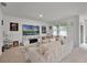 Bright living room featuring a plush sofa, large TV, and neutral carpet throughout at 1351 Fox Squirrel Dr, Davenport, FL 33897