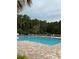A beautiful pool area surrounded by brick pavers and lush green landscaping at 1351 Fox Squirrel Dr, Davenport, FL 33897