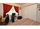 Bedroom featuring a brown and tan patterned bedspread and white closet doors at 1390 E Airport Blvd, Sanford, FL 32773
