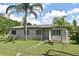 Well-kept single-story home with a spacious front yard and inviting entryway at 1390 E Airport Blvd, Sanford, FL 32773