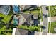 Overhead shot of a house with a screened pool, solar panels, and a well-maintained yard at 13924 Jomatt Loop, Winter Garden, FL 34787