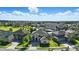 Wide aerial view of a neighborhood with houses, green spaces, and blue skies at 13924 Jomatt Loop, Winter Garden, FL 34787