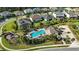 Scenic aerial view of a community pool, playground, and lush landscaping nestled among well-kept homes at 13924 Jomatt Loop, Winter Garden, FL 34787