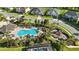 Aerial view of the community pool, playground, and manicured landscaping with surrounding residences at 13924 Jomatt Loop, Winter Garden, FL 34787