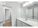 This bathroom features a single sink vanity with a large mirror and is adjacent to a shower at 13924 Jomatt Loop, Winter Garden, FL 34787