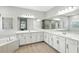 Bathroom featuring double sinks, a large mirror, and a soaking tub at 13924 Jomatt Loop, Winter Garden, FL 34787