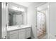 This bathroom features a single sink vanity with a large mirror and a shower with a Paris-themed curtain at 13924 Jomatt Loop, Winter Garden, FL 34787