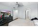 A spacious bedroom features a large dresser, a ceiling fan, and access to the hallway and bathroom at 13924 Jomatt Loop, Winter Garden, FL 34787
