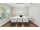 Modern dining area featuring a sleek chandelier, white brick accent wall, and contemporary furnishings at 13924 Jomatt Loop, Winter Garden, FL 34787