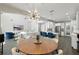 Open dining area with views of the kitchen, living room, and modern lighting at 13924 Jomatt Loop, Winter Garden, FL 34787