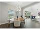 Dining area with natural light and views of the pool and living room at 13924 Jomatt Loop, Winter Garden, FL 34787