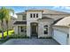 Beautiful two-story home with stone detailing, well-maintained landscaping, and a stylish facade at 13924 Jomatt Loop, Winter Garden, FL 34787