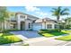 Charming two-story home with a paver driveway, attached garage, and well-maintained landscaping at 13924 Jomatt Loop, Winter Garden, FL 34787