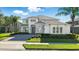 Stunning two-story home featuring stone accents, a paved driveway, and lush landscaping at 13924 Jomatt Loop, Winter Garden, FL 34787