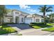 Beautiful home with a three-car garage, manicured lawn, and stone detailing on the facade at 13924 Jomatt Loop, Winter Garden, FL 34787