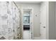 Hallway adjacent to a bathroom and a bedroom with an arched doorway looking out the window at 13924 Jomatt Loop, Winter Garden, FL 34787