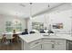 Kitchen featuring quartz counters, an island, and an open view of the living room and pool at 13924 Jomatt Loop, Winter Garden, FL 34787