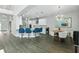 Modern kitchen with a breakfast bar, stainless steel appliances, and an adjacent dining area at 13924 Jomatt Loop, Winter Garden, FL 34787