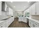Bright kitchen with stainless steel appliances, white cabinetry, and views of the pool at 13924 Jomatt Loop, Winter Garden, FL 34787