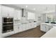 Well-appointed kitchen with stainless steel appliances and white cabinets, open to the dining area at 13924 Jomatt Loop, Winter Garden, FL 34787