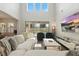 Spacious living room featuring soaring ceilings, large windows, and a view of the pool at 13924 Jomatt Loop, Winter Garden, FL 34787