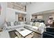 Open-concept living area with a loft overlook, leading to a kitchen with an island and bar stools at 13924 Jomatt Loop, Winter Garden, FL 34787