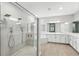 Beautiful bathroom features an expansive glass shower, separate soaking tub, and double vanities at 13924 Jomatt Loop, Winter Garden, FL 34787