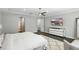 Spacious main bedroom features wood floors, TV, and a view of the ensuite bathroom at 13924 Jomatt Loop, Winter Garden, FL 34787