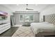 Spacious main bedroom with a tray ceiling, textured wall, and plenty of natural light at 13924 Jomatt Loop, Winter Garden, FL 34787