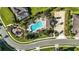 Aerial perspective of the pool, playground, and parking lot in this well-maintained residential community at 13924 Jomatt Loop, Winter Garden, FL 34787