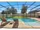 Relaxing screened-in pool area with inviting lounge chairs, perfect for enjoying sunny days outdoors at 13924 Jomatt Loop, Winter Garden, FL 34787