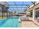 Stunning screened-in pool area with an outdoor kitchen and dining, ideal for enjoying outdoor living at 13924 Jomatt Loop, Winter Garden, FL 34787