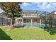 Peaceful backyard pool area, fully screened-in with an outdoor kitchen and a comfortable lounging space at 13924 Jomatt Loop, Winter Garden, FL 34787