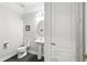 Elegant powder room with modern fixtures, a pedestal sink, and stylish decor at 13924 Jomatt Loop, Winter Garden, FL 34787