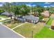 Aerial view of the home features a landscaped yard, mature trees, a long driveway, and well-maintained neighborhood at 1484 Lake Francis Dr, Apopka, FL 32712