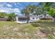 Backyard view with a sparkling pool, patio, and lush landscaping at 1484 Lake Francis Dr, Apopka, FL 32712