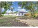Exterior home view with pool and backyard space. Home features a modern black and white paint scheme at 1484 Lake Francis Dr, Apopka, FL 32712