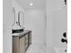 Bathroom featuring modern double vanity with sleek fixtures, marble floors, and walk-in shower at 1484 Lake Francis Dr, Apopka, FL 32712