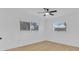 Bright bedroom featuring wood floors, a ceiling fan, and natural light from two windows at 1484 Lake Francis Dr, Apopka, FL 32712