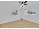 Serene bedroom featuring hardwood floors, dual windows, and a ceiling fan at 1484 Lake Francis Dr, Apopka, FL 32712