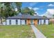 Charming single story home with a well-manicured lawn and a welcoming walkway at 1484 Lake Francis Dr, Apopka, FL 32712