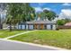 Charming home with manicured lawn, updated exterior, and a welcoming front yard, showcasing curb appeal at 1484 Lake Francis Dr, Apopka, FL 32712