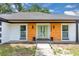 Charming home exterior with a new front door, modern lighting, and beautifully maintained front yard at 1484 Lake Francis Dr, Apopka, FL 32712