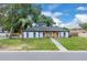 Charming single story home features modern updates, black roof, a green front door, and a well-manicured lawn at 1484 Lake Francis Dr, Apopka, FL 32712