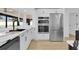 Modern kitchen with stainless steel appliances, white cabinets, and sleek countertops, with a bright and airy feel at 1484 Lake Francis Dr, Apopka, FL 32712