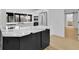 Open-concept kitchen featuring a stylish island with quartz countertops and modern black cabinetry at 1484 Lake Francis Dr, Apopka, FL 32712