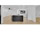 Eat-in kitchen featuring stainless appliances, a bright window and a black island with quartz countertop at 1484 Lake Francis Dr, Apopka, FL 32712