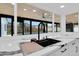 Modern kitchen sink featuring sleek countertops, a stylish faucet, and a window overlooking the pool at 1484 Lake Francis Dr, Apopka, FL 32712